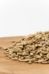 Pile of sunflower seeds on the wooden board
