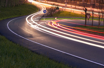 Cars lights in the road at night.