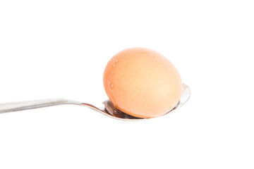 egg on a spoon, isolated on white background