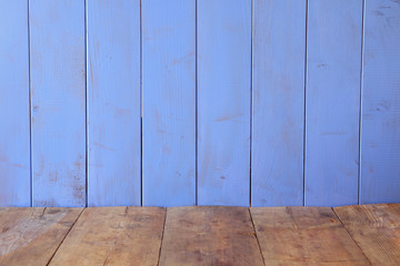 wooden table in front of blue wooden background. product display background
