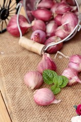 raw shallots for cooking on wood background.