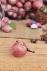 raw shallots for cooking on wood background.