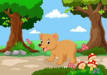Funny baby bear with a background of a beautiful garden