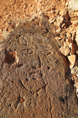 Prehistoric engraved stone face imitation