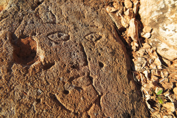 Prehistoric engraved stone face imitation