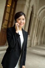 Businesswoman talk to mobile phone in Hong Kong city