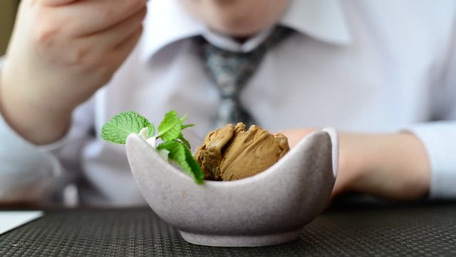 Teen Boy Eating Ice Cream In Cafe