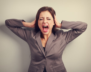 Angry business woman in suit strong screaming with wild open mou