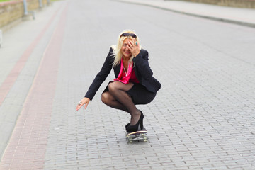 Senior business woman having fun on a skateboard outdoors. adult woman on a skateboard. business woman on a skateboard