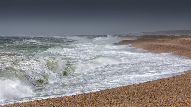 Storm waves battering Chesil Beach on Dorset's Jurassic Coast.