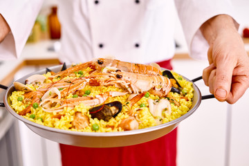 Cooked fideua valencia served by chef