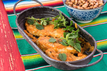 Fresh cooked chicken breast with chili sauce in a skillet.