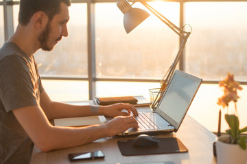 business man working on laptop at desk in office