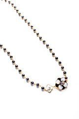 necklace with flower and black beads isolated close up