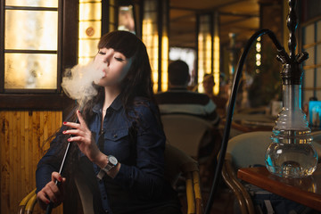 Beautiful young woman with hookah