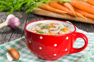 spring garlic carrot soup with mushrooms, closeup