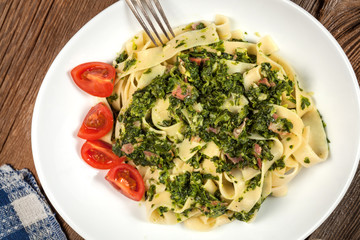 Spaghetti with spinach and bacon.