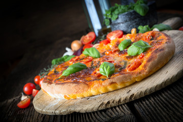 homemade pizza margherita with mozzarella, basil and tomatoes