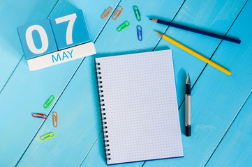 May 7th. Image of may 7 wooden color calendar on blue background.  Spring day, empty space for text