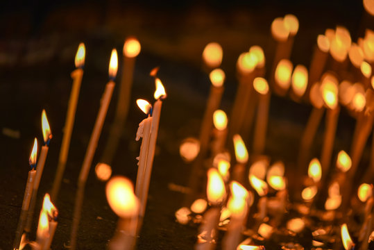 Lit candles in a church in natural light
