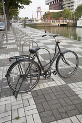 Fototapeta na wymiar Bike Parked next to Canal, Rotterdam