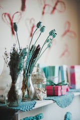 Poppy flowers bouquet and feathers on the crocheted napkin