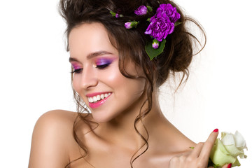 Naklejka premium Portrait of young beautiful female holding white rose with viole