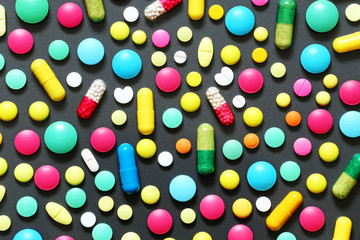 Colorful pills on grey background