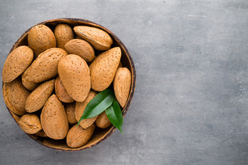 Group of almond nuts with leaves.Wooden background.