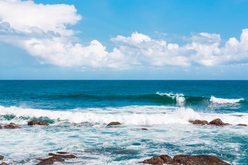 Big wave with sea foam and turquoise water.