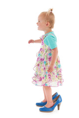 Toddler girl in mothers big shoes