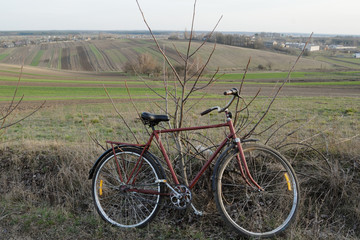 Red bicycle as little part of landscape