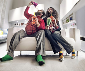 Funny portrait of two friends watching tv