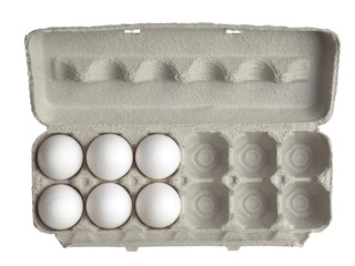 top view of half dozen eggs in a tray.