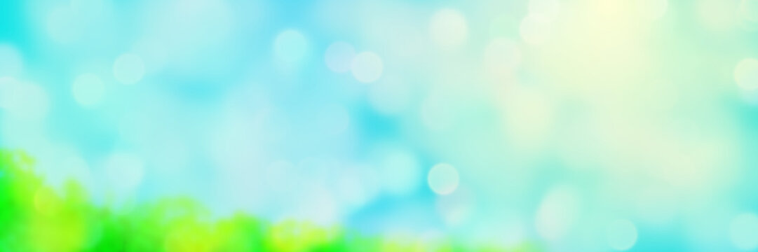 soft sunlit background in white, green and blue with bright bokeh effects
