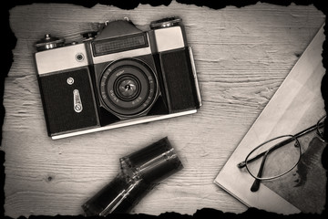 Old manual camera with newspaper and film
