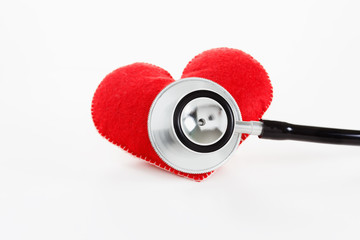 Red heart and a stethoscope on white background
