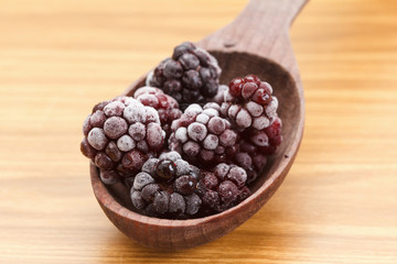 Macro view on frozen Blackberry fruits in spoon