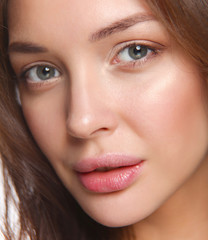 Close up portrait of beautiful young woman face. Isolated on white background.