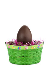 one big brown easter egg in green basket.