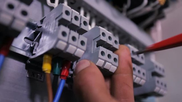 Electrician connects wires. Close up.