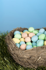 cropped image of colorful eggs in a nest