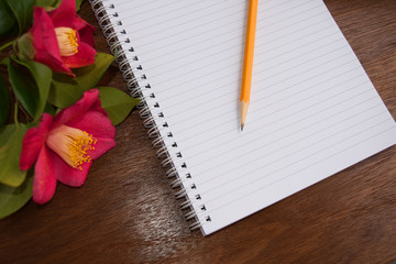 Notebooks and pensil with romantic pink flowers