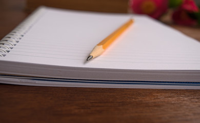 Notebooks and pensil with romantic pink flowers