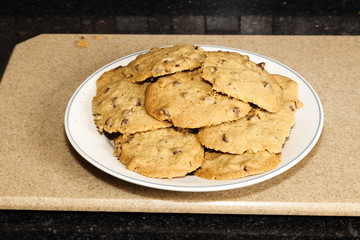 White Plate With Pile Of Cooked Cholocate Chip Cookies
