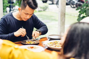Friends Enjoying Meal In Outdoor Restaurant
