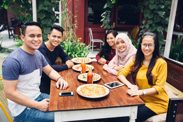 Friends Enjoying Meal In Outdoor Restaurant