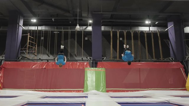 Three Professional gymnasts doing trcks on trampoline synchrone. Amazing tricks by Group of Gymnasts.
