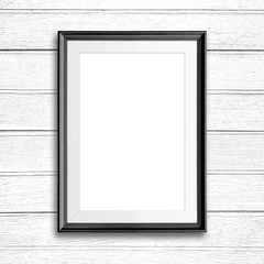Black picture frame on white wood wall.