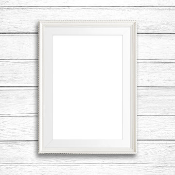 White picture frame on white wood wall.